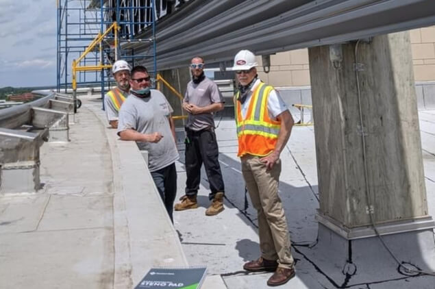 Four Apple Signs sign installers working at a job site